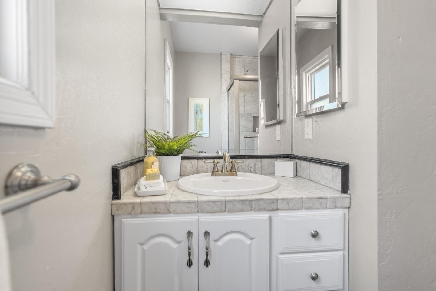 132 Bancroft Road Burlingame, CA 94010 - Photo 25 of 39 a bathroom with a sink and a mirror