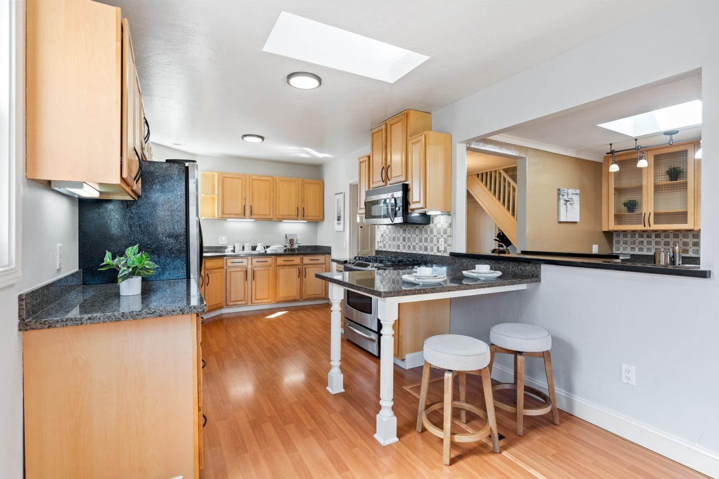 132 Bancroft Road Burlingame, CA 94010 - Photo 7 of 39 a kitchen with granite countertop a stove a sink and a refrigerator