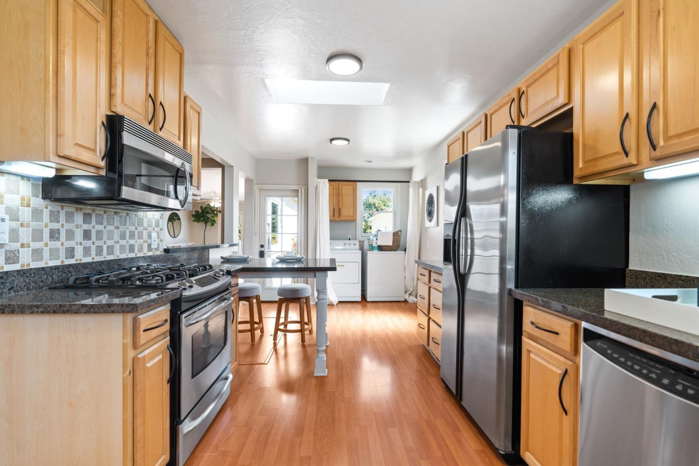 132 Bancroft Road Burlingame, CA 94010 - Photo 8 of 39 a kitchen with stainless steel appliances granite countertop a refrigerator a stove a sink and a microwave