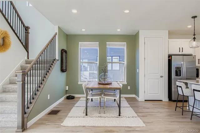 a living room with furniture and a table with wooden floor