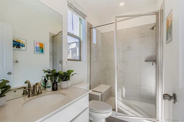 a bathroom with a shower curtain a sink a toilet and a mirror