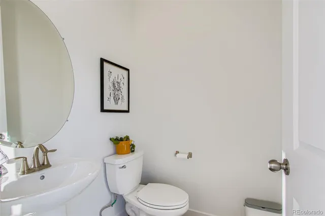 a white toilet sitting next to a bathroom sink