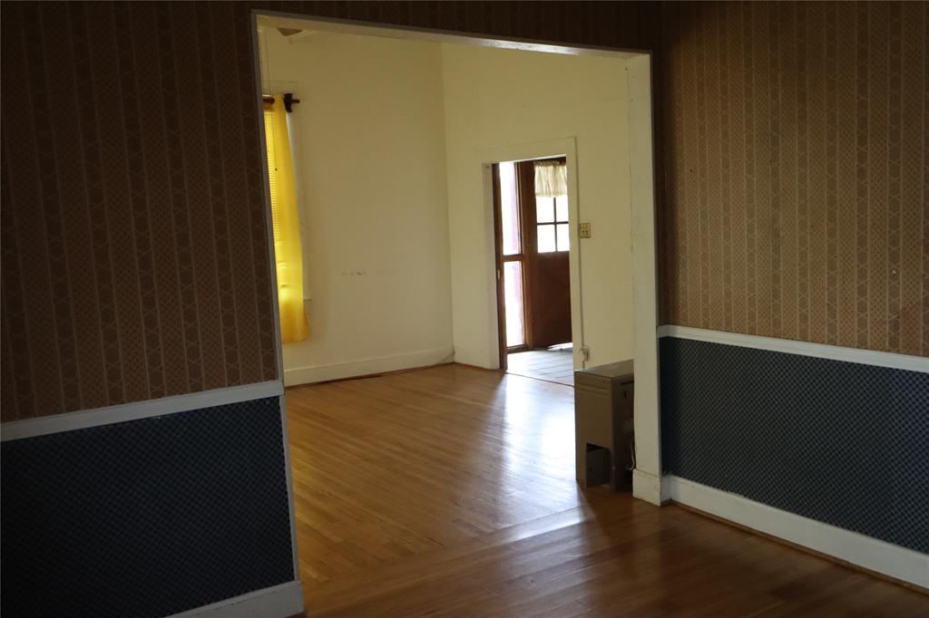 431 Walnut Street Ranger, TX 76470 - Photo 13 of 37 a view of a hallway with wooden floor