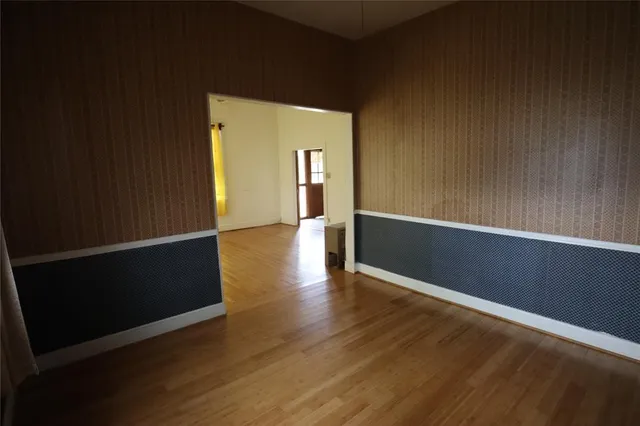 a view of a livingroom with wooden floor and a window