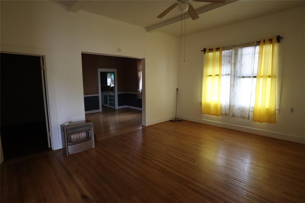 431 Walnut Street Ranger, TX 76470 - Photo 16 of 37 a view of a livingroom with wooden floor and a window