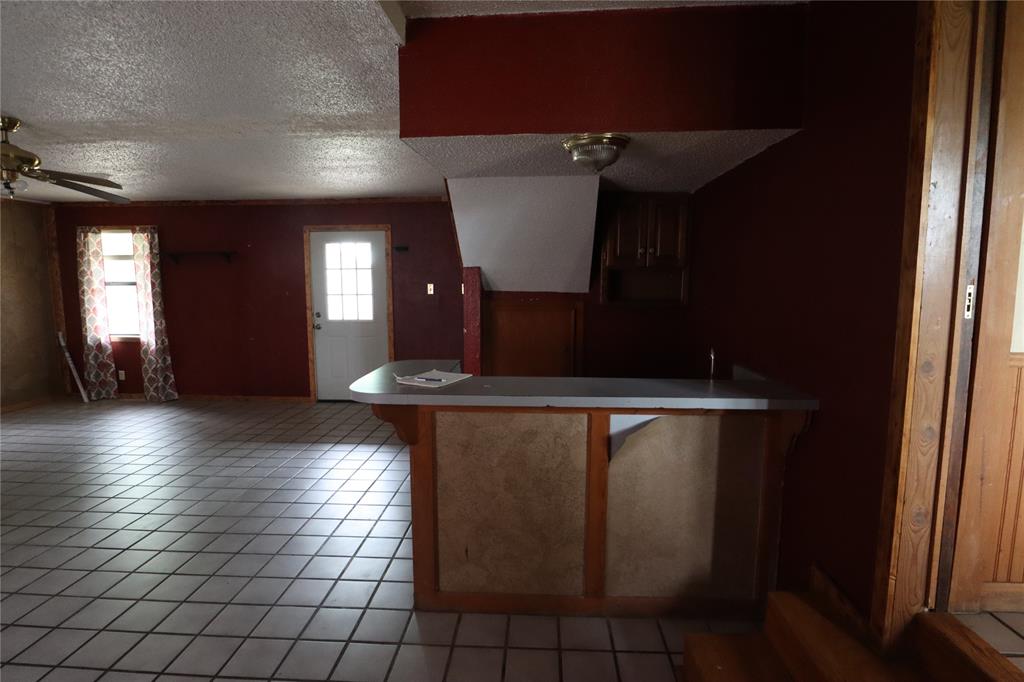 431 Walnut Street Ranger, TX 76470 - Photo 20 of 37 a view of an empty room with wooden floor and a window