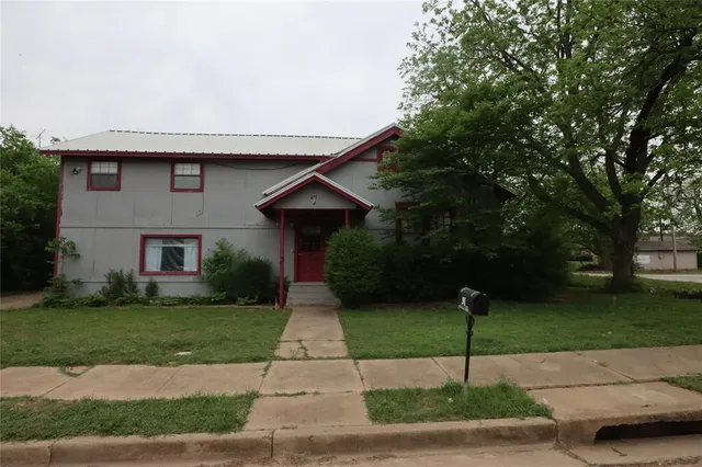 a front view of a house with garden