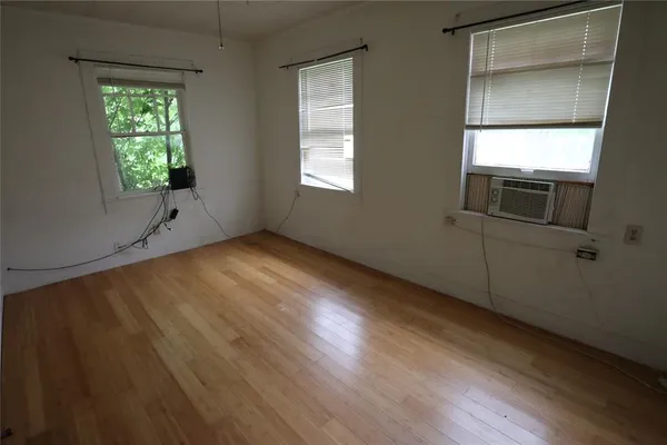 a view of a storage and utility room with refrigerator