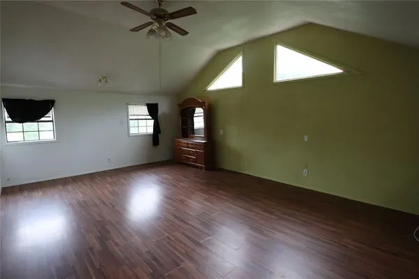 a view of hallway with stairs and wooden floor