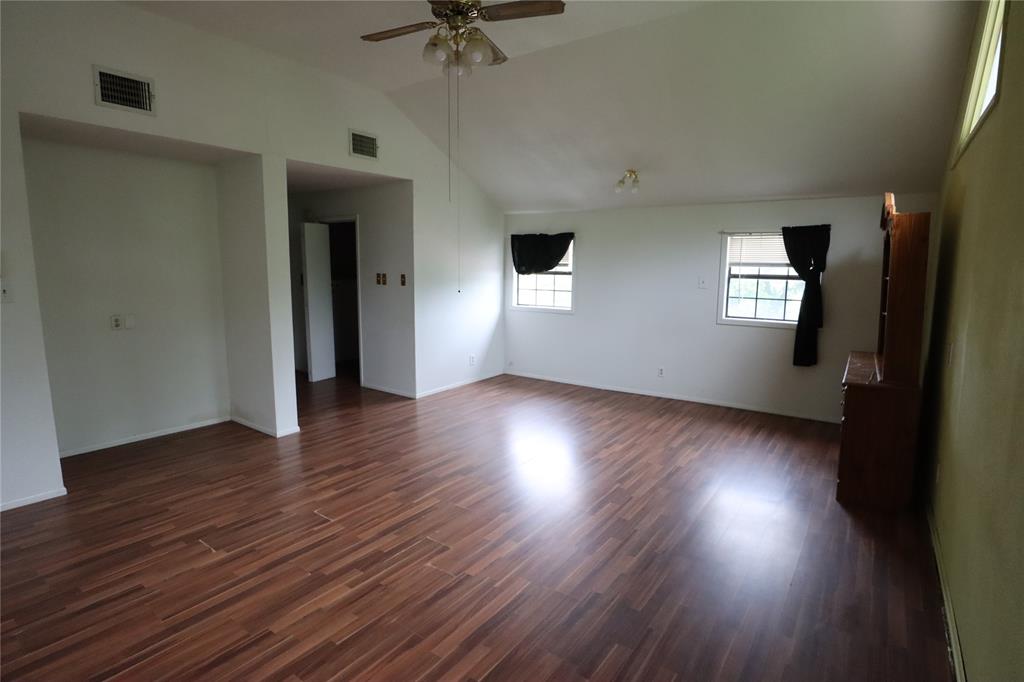431 Walnut Street Ranger, TX 76470 - Photo 33 of 37 a view of an empty room with wooden floor and a window