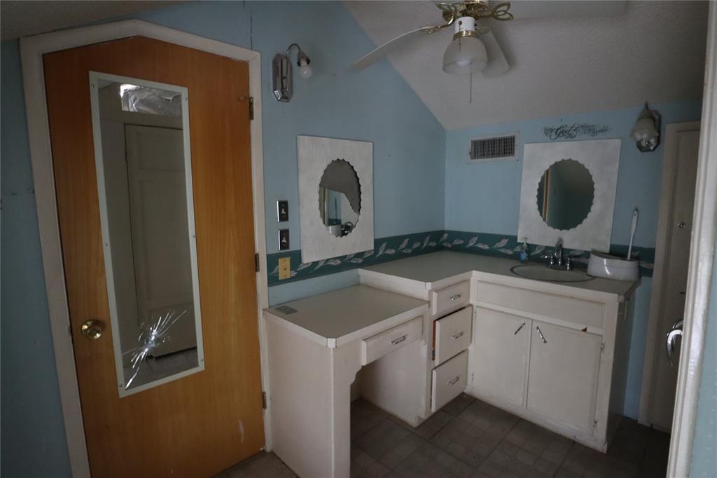 431 Walnut Street Ranger, TX 76470 - Photo 36 of 37 a room with a sink and a mirror
