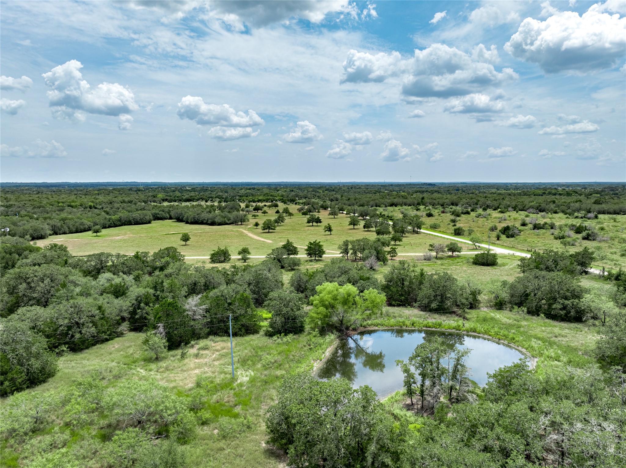 1345 Davis Road Muldoon, TX 78949 - Photo 2 of 25 an aerial view of residential houses with outdoor space and trees