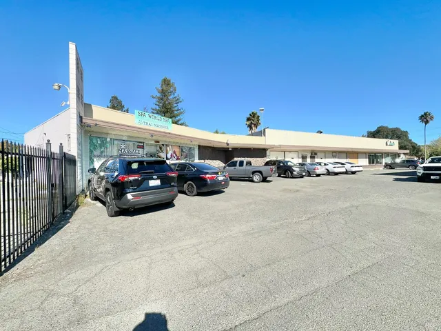 a view of a patio with a dining table chairs and a swimming pool