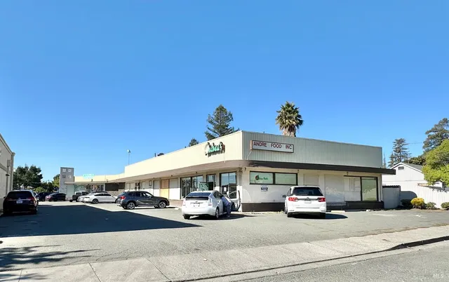 a room with lots of wooden furniture and white walls