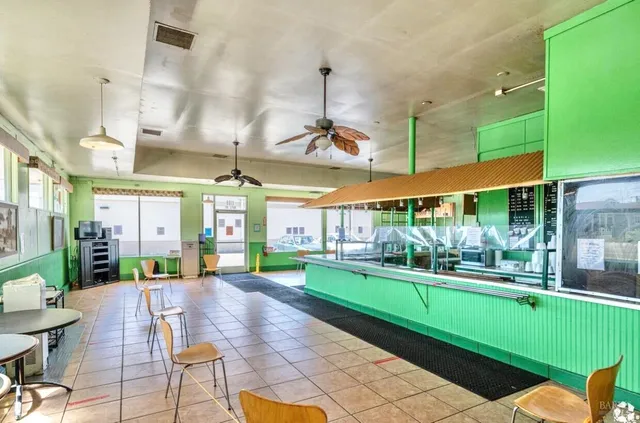 a view of a kitchen with a dining table chairs and a swimming pool