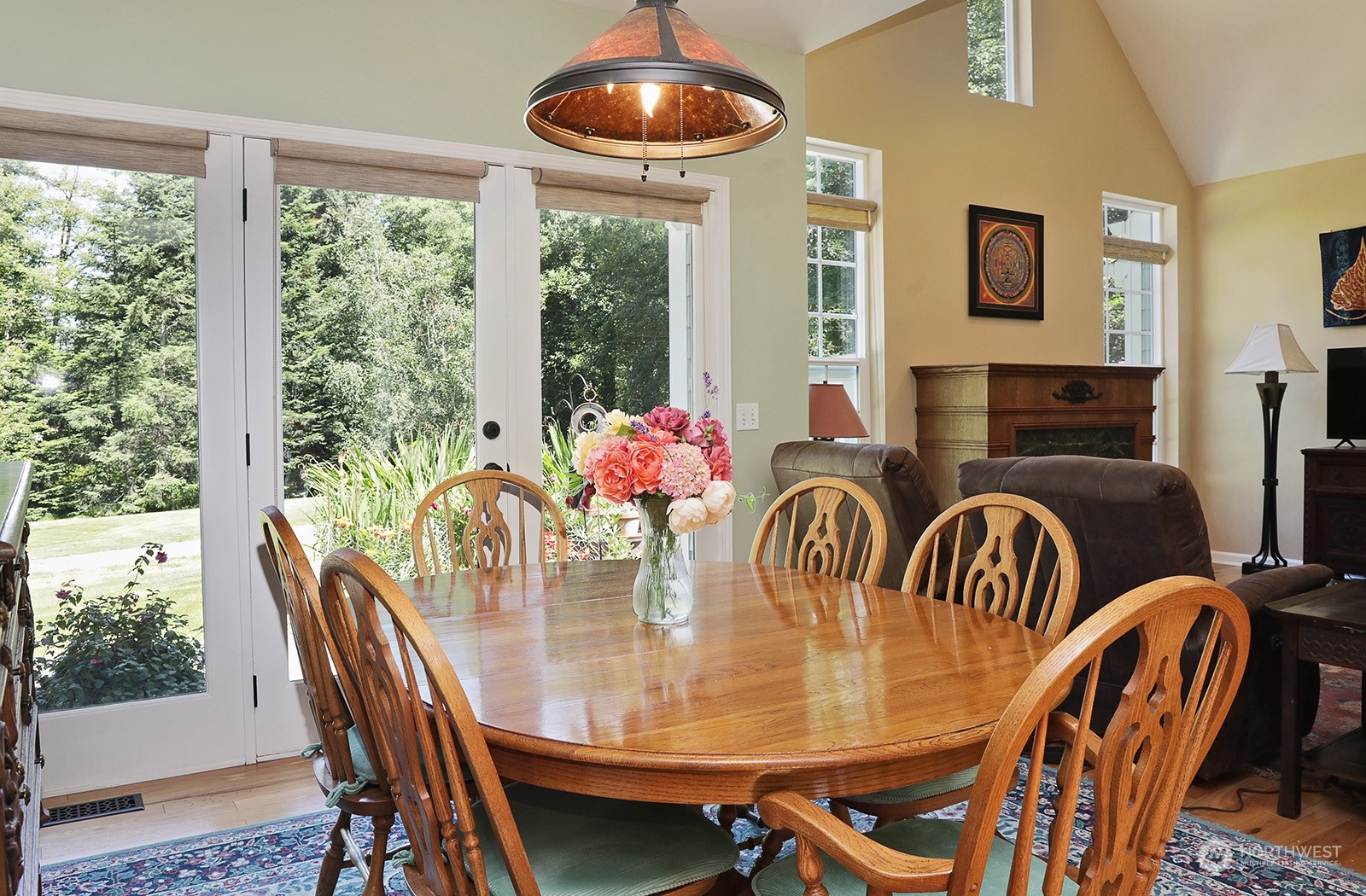 6501 Wahl Road Freeland, WA 98249 - Photo 7 of 40 a dining room with furniture garden view and a chandelier
