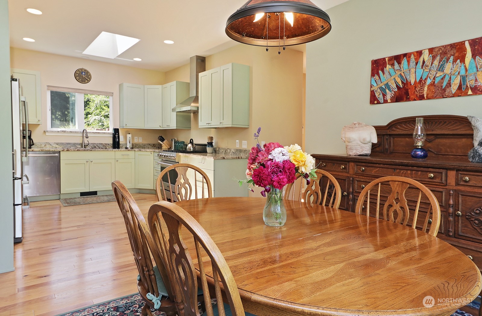 6501 Wahl Road Freeland, WA 98249 - Photo 8 of 40 a kitchen with stainless steel appliances granite countertop a dining table chairs and stove
