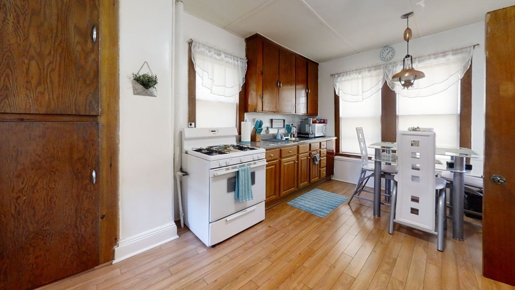 49 Braeburn Road Boston, MA 02136 - Photo 5 of 18 a kitchen with stainless steel appliances a stove a sink and a refrigerator