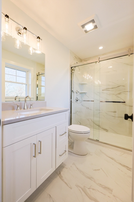58 Baltic Street, Unit 58 Attleboro, MA 02703 - Photo 25 of 34 a bathroom with a toilet sink and a shower