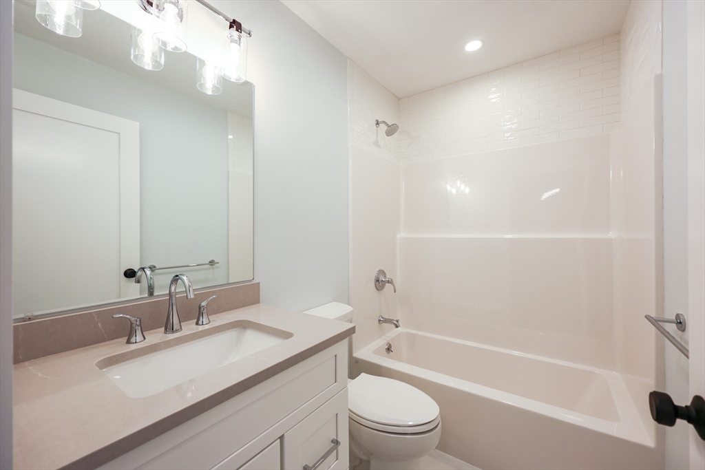 58 Baltic Street, Unit 58 Attleboro, MA 02703 - Photo 28 of 34 a bathroom with a sink a toilet and shower