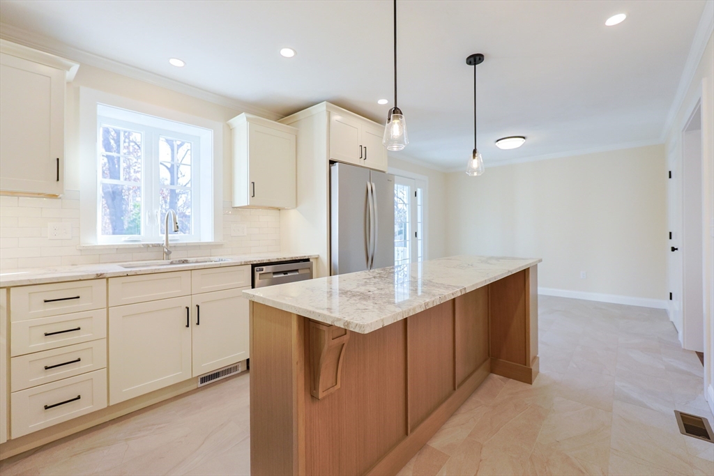 58 Baltic Street, Unit 58 Attleboro, MA 02703 - Photo 6 of 34 a kitchen with a sink chandelier and refrigerator