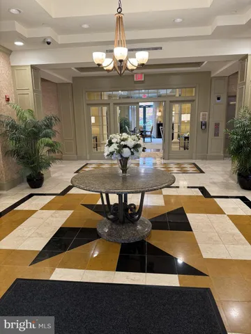 a view of a lobby with table and chairs
