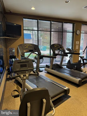 a room with gym equipment and a large window