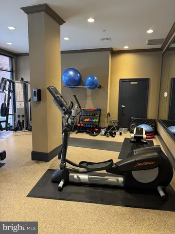 a room with gym equipment and a large window