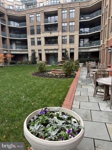 a view of a house with backyard sitting area and garden