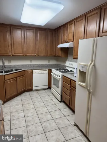 a kitchen with cabinets a sink and appliances