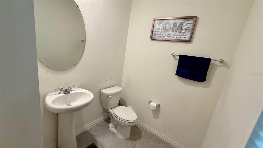 13340 Pontoon Road Winter Garden, FL 34787 - Photo 4 of 15 a bathroom with a toilet a sink and mirror