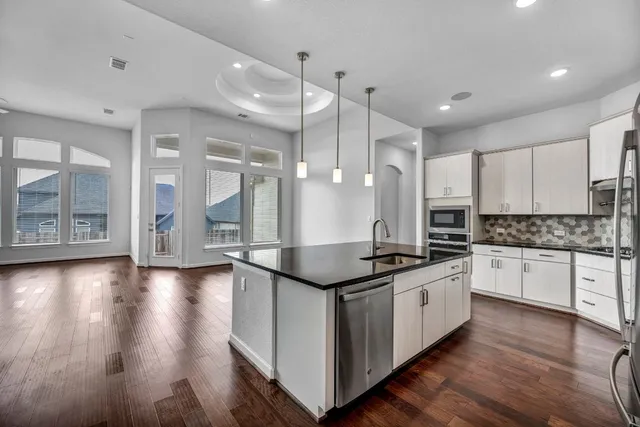 a kitchen with stainless steel appliances granite countertop a stove and a sink