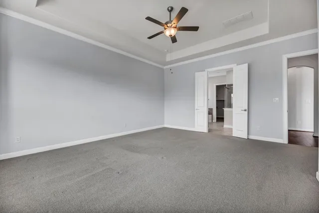 a view of a livingroom with a ceiling fan and window