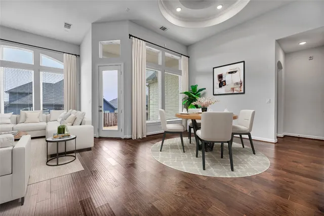 a view of a dining room with furniture and wooden floor