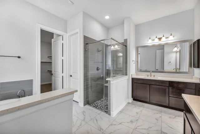 a bathroom with a bathtub shower sink and mirror