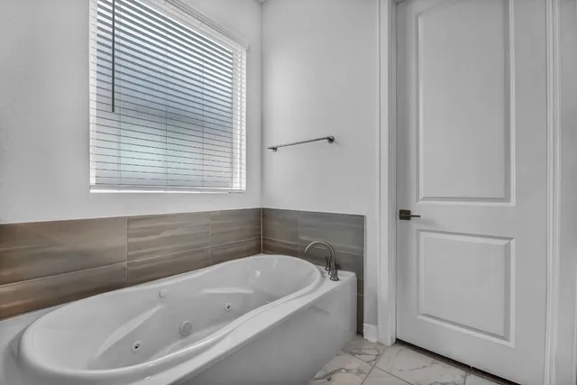a white bath tub sitting next to a window
