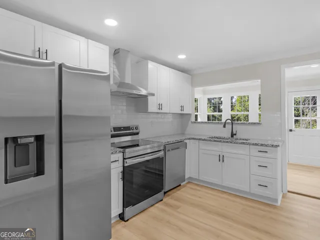 a kitchen with cabinets and steel stainless steel appliances