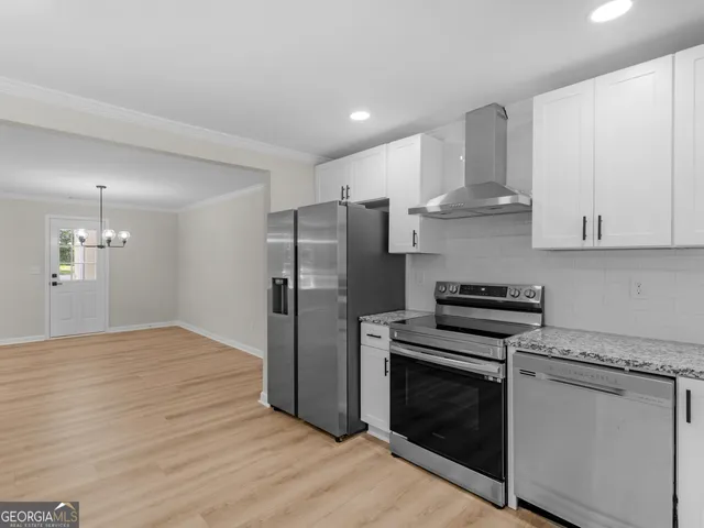 a kitchen with granite countertop white cabinets and sink