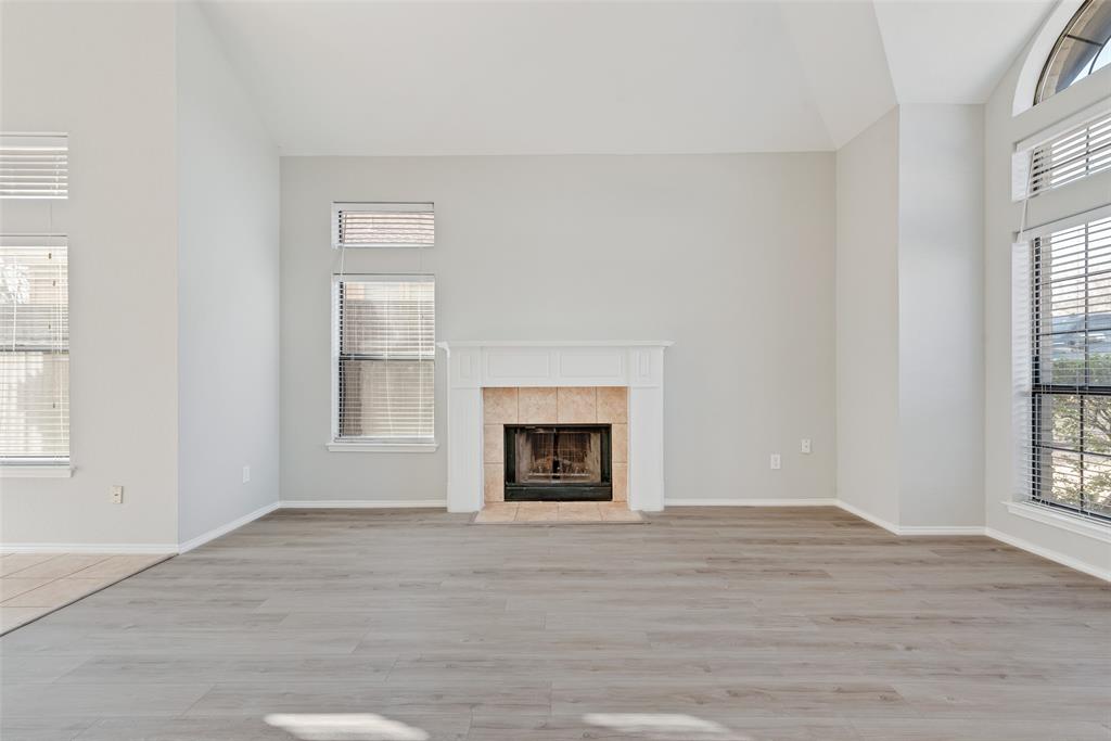 903 Ragland Drive Cedar Hill, TX 75104 - Photo 12 of 33 a view of an empty room with wooden floor windows and a fireplace