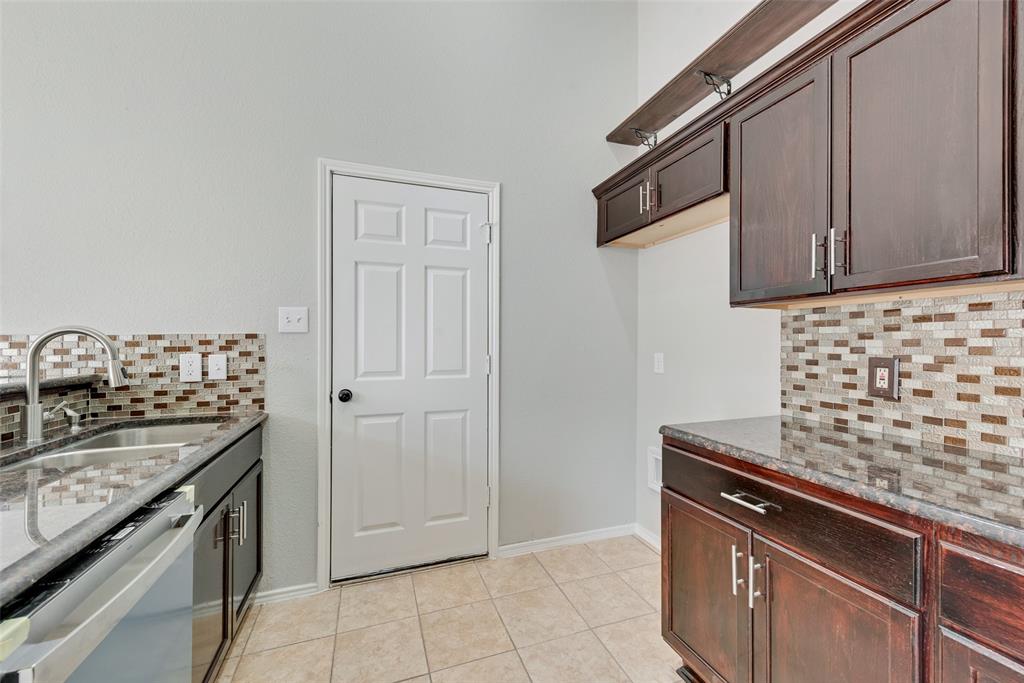 903 Ragland Drive Cedar Hill, TX 75104 - Photo 14 of 33 a kitchen with granite countertop a sink and a stove