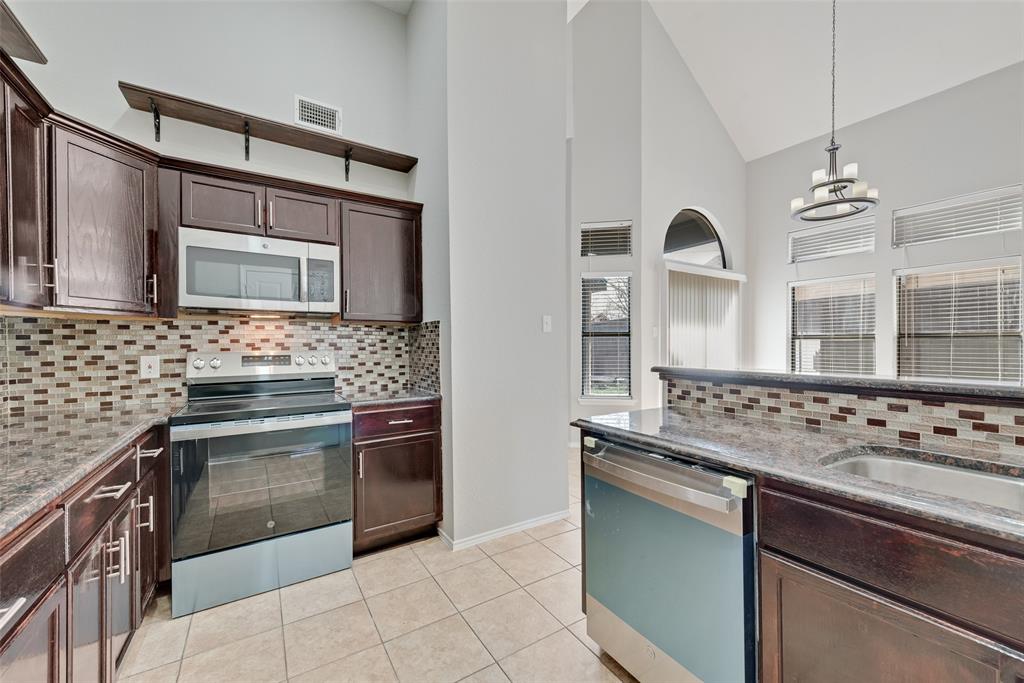 903 Ragland Drive Cedar Hill, TX 75104 - Photo 15 of 33 a kitchen with stainless steel appliances granite countertop a stove and a sink