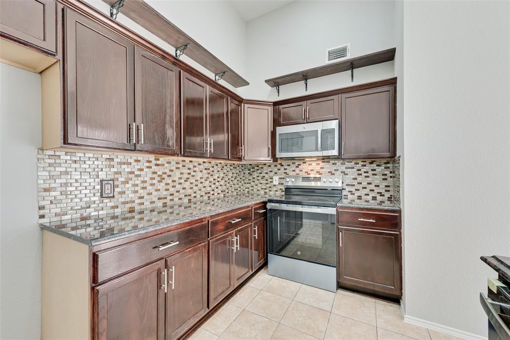 903 Ragland Drive Cedar Hill, TX 75104 - Photo 16 of 33 a kitchen with stainless steel appliances granite countertop a sink stove and cabinets