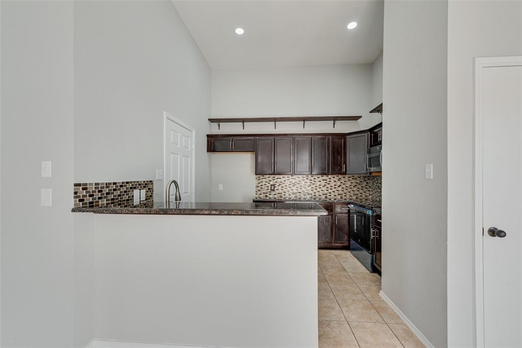903 Ragland Drive Cedar Hill, TX 75104 - Photo 18 of 33 a kitchen with stainless steel appliances granite countertop a sink and a stove