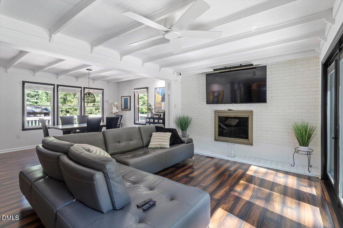 2129 Kelly Road Apex, NC 27502 - Photo 19 of 64 a living room with furniture a fireplace and a flat screen tv