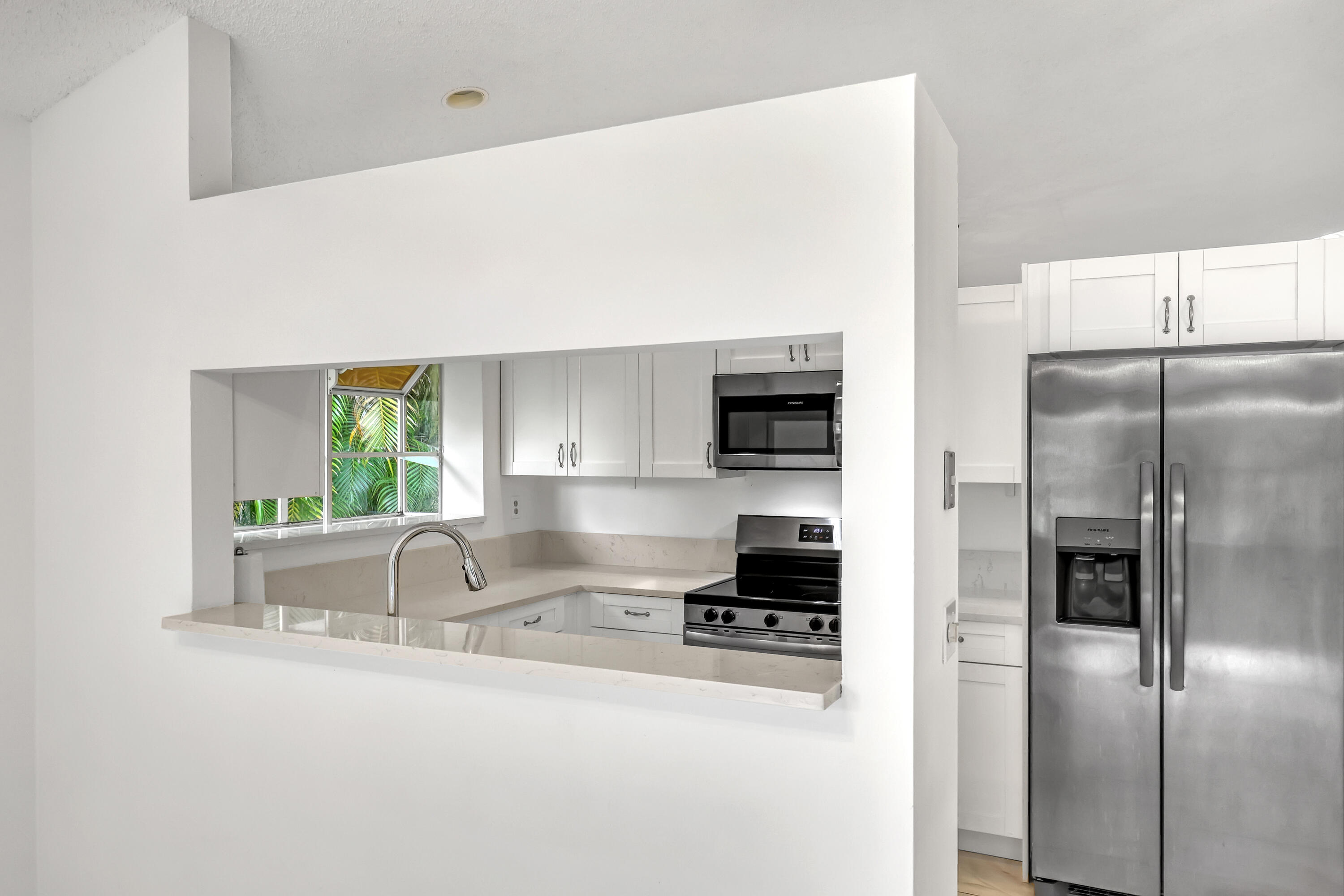 11120 Rios Road Boca Raton, FL 33498 - Photo 15 of 36 a kitchen with stainless steel appliances granite countertop a refrigerator a stove and a sink