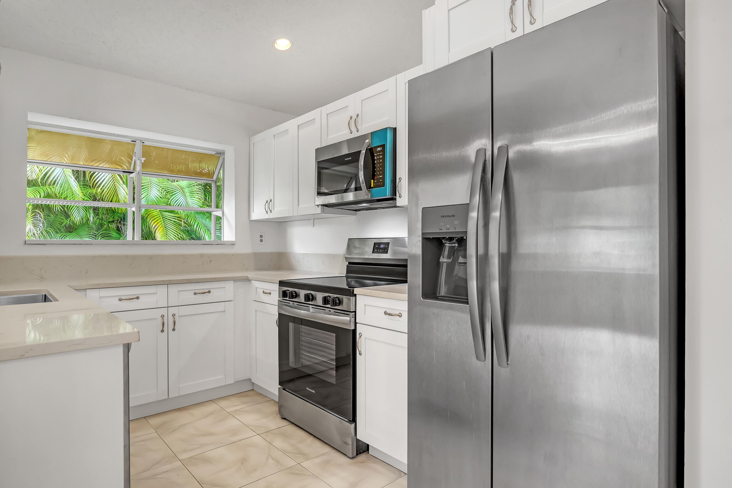 11120 Rios Road Boca Raton, FL 33498 - Photo 16 of 36 a kitchen with a refrigerator stove and microwave
