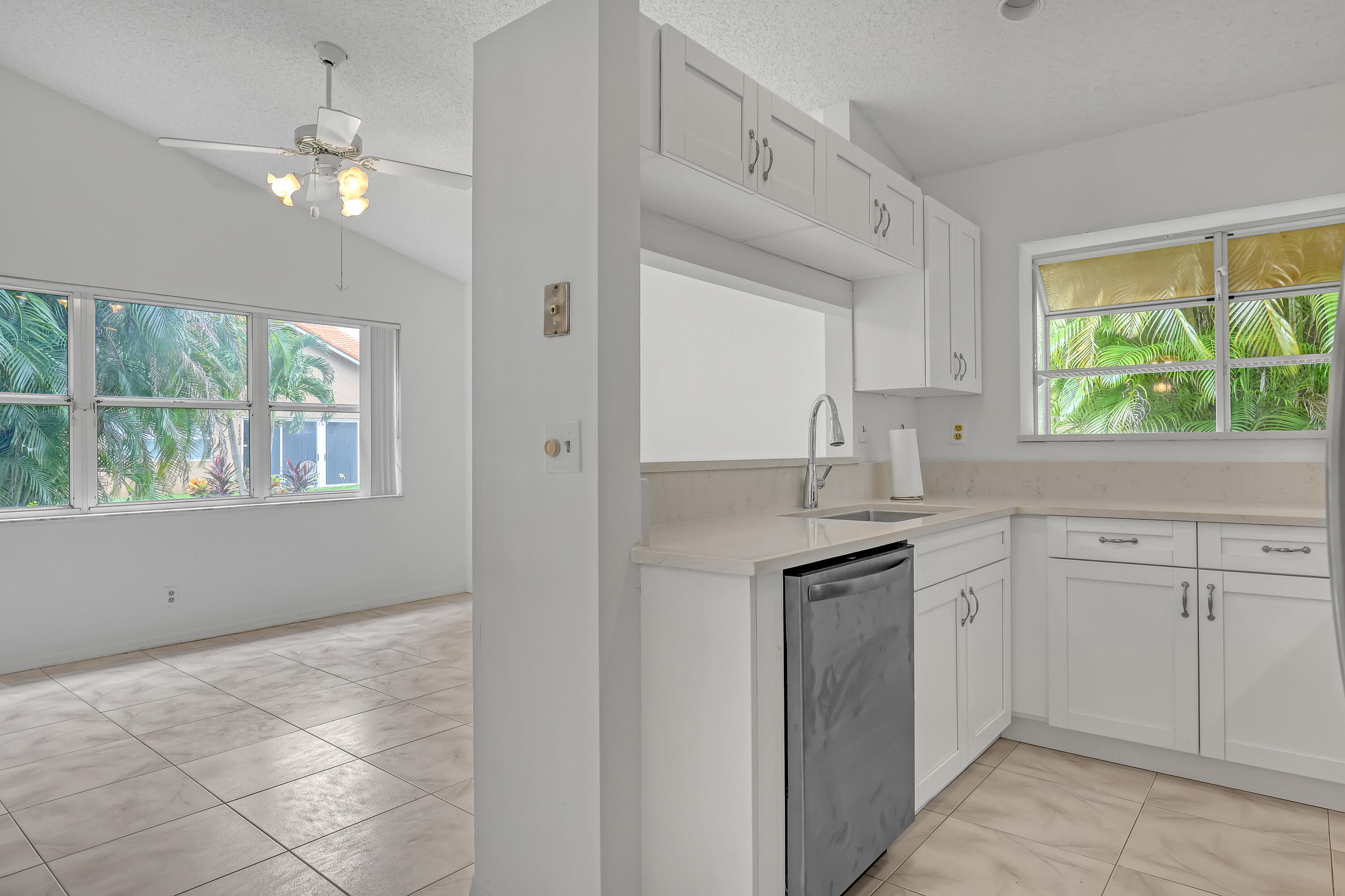 11120 Rios Road Boca Raton, FL 33498 - Photo 17 of 36 a kitchen with granite countertop a stove sink and cabinets