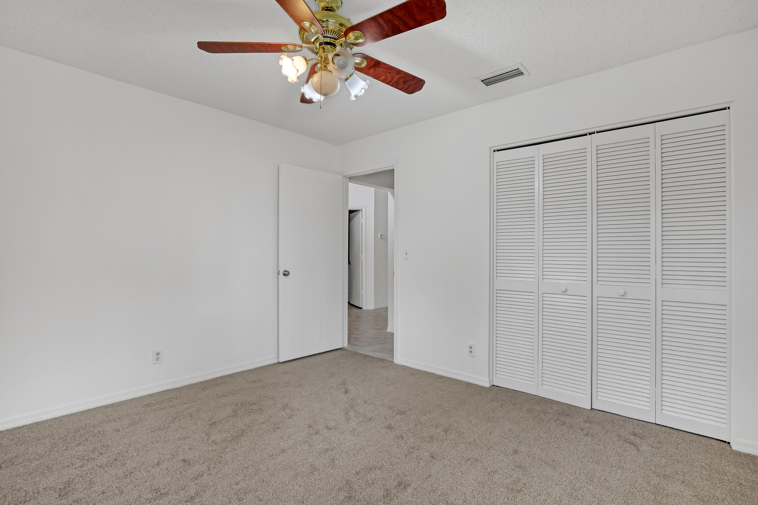 11120 Rios Road Boca Raton, FL 33498 - Photo 28 of 36 an empty room with chandelier fan