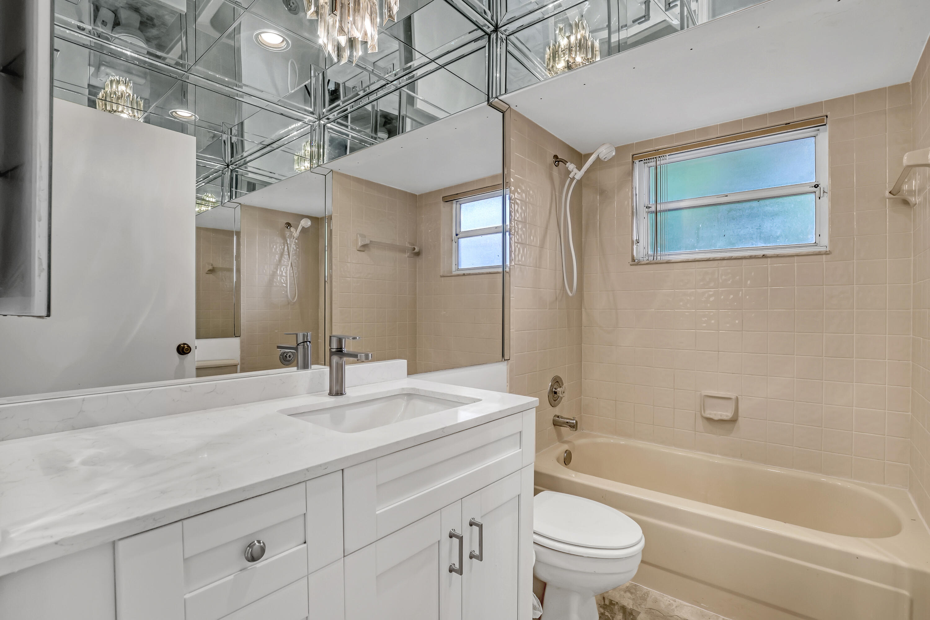 11120 Rios Road Boca Raton, FL 33498 - Photo 30 of 36 a bathroom with a sink a toilet and a bathtub