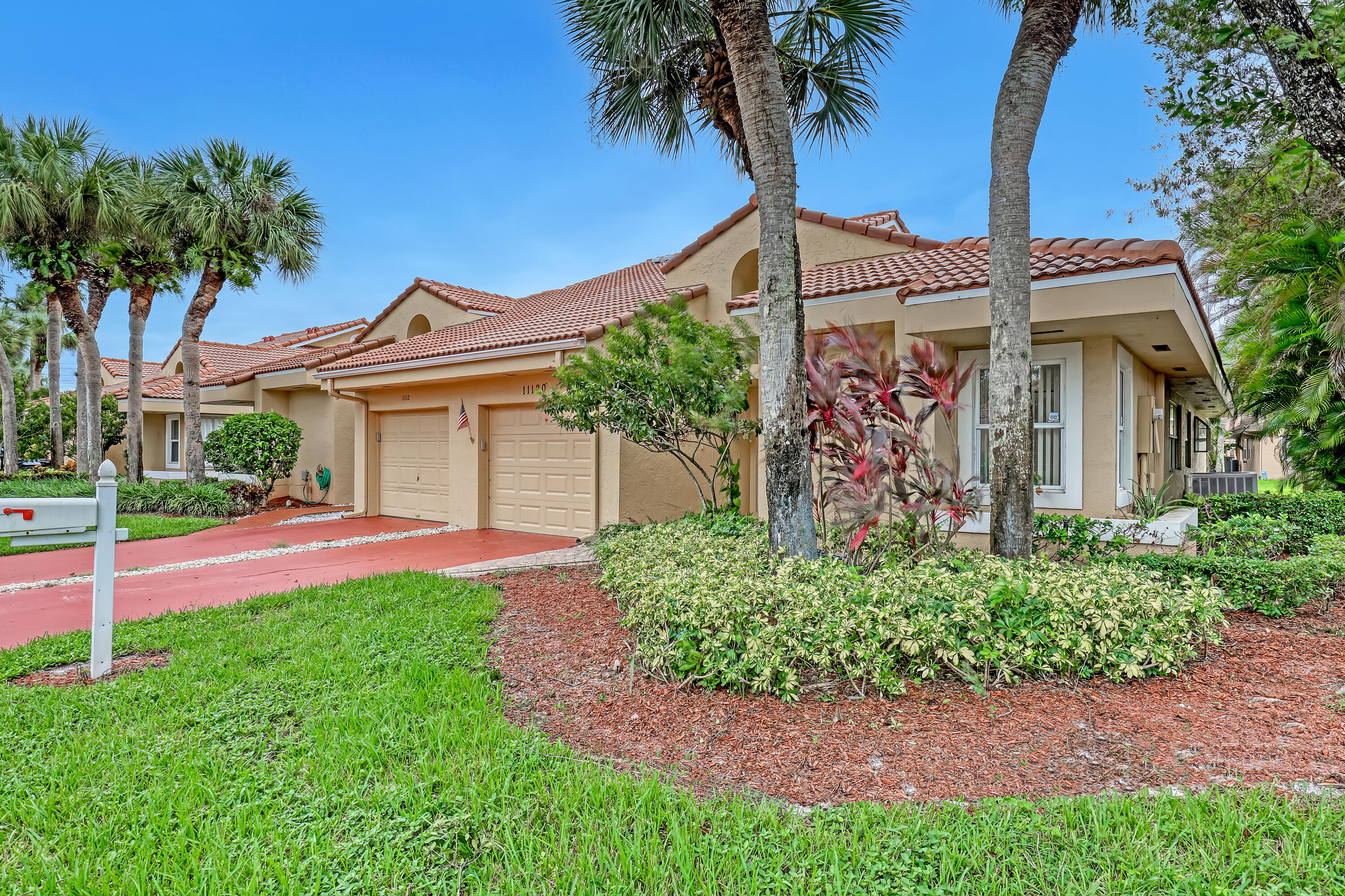 11120 Rios Road Boca Raton, FL 33498 - Photo 3 of 36 front view of a house with a garden